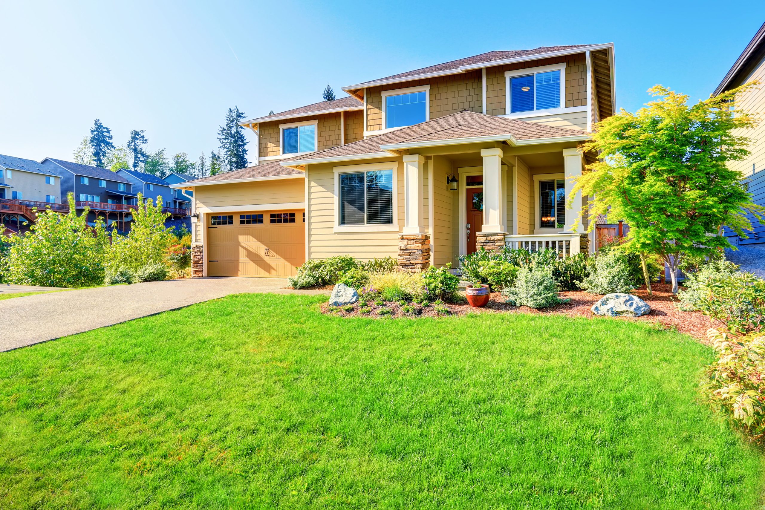 A house in Collingwood with a green lawn and a driveway that needs painters.